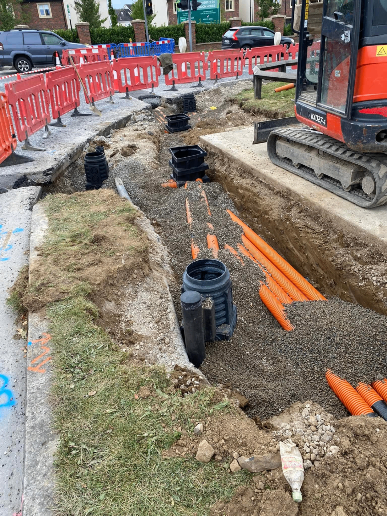 Drainage trench with orange ducting and chambers