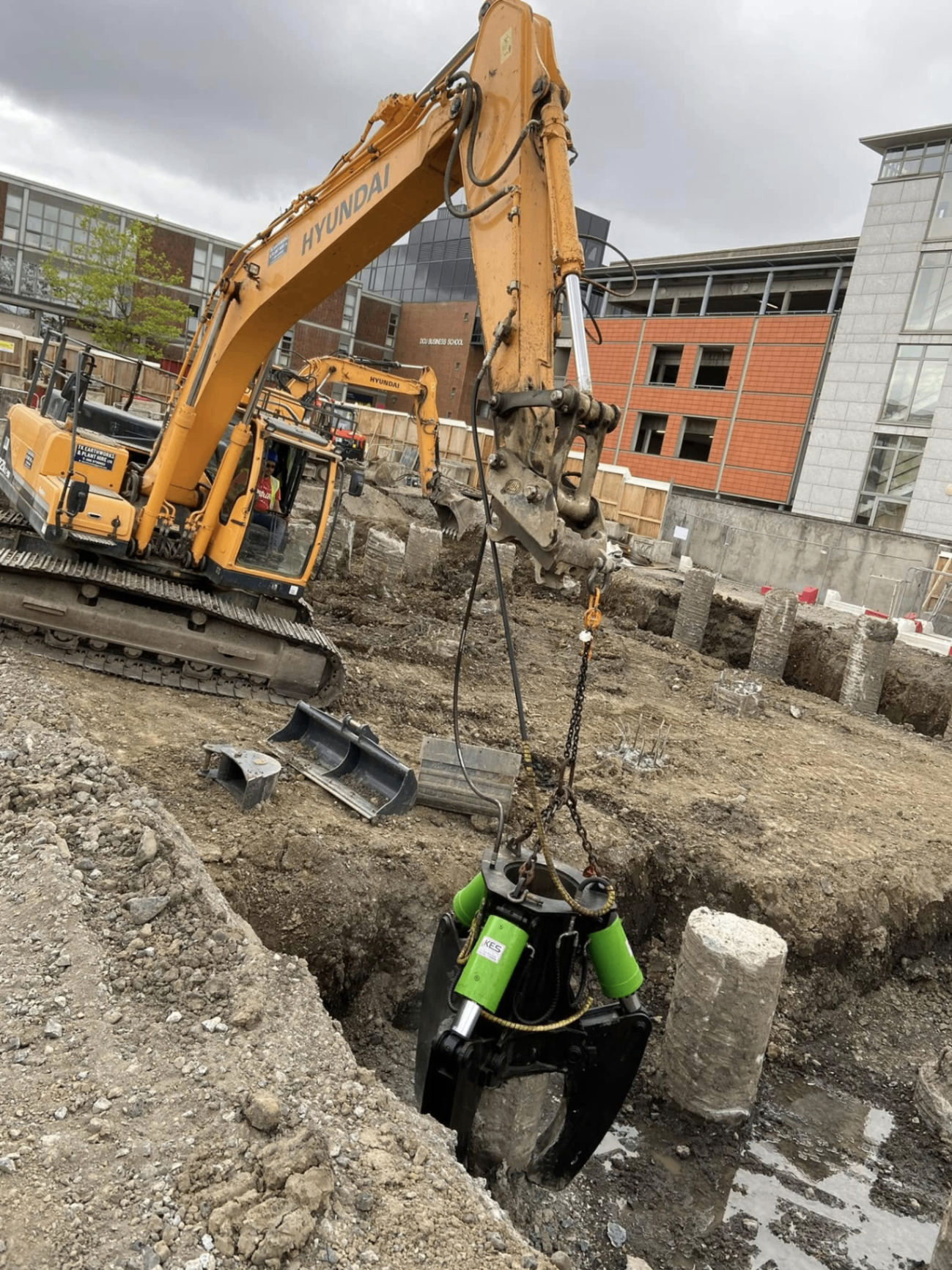 Pile cutting with Hyundai excavator on urban site